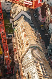 Close-up of construction work on a roof with workers in an urban environment, carpentry,