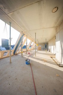 Light-flooded interior on a construction site with construction supports and woodwork, carpentry,