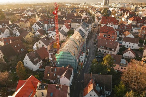 Urban scene with a construction site and surrounding residential buildings from a bird's eye view,