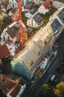 Overview of a large construction site in a residential area during roof renovation, carpentry,