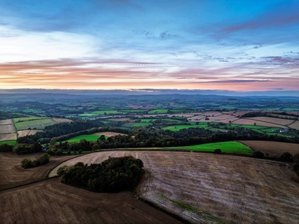 Sunset of Devon Farms and Fields over Berry Pomeroy from a drone, Totnes, England, United Kingdom