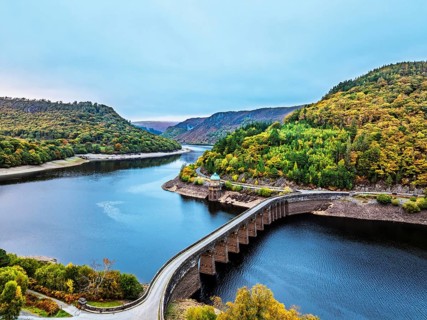 Autumn over Garreg Ddu Dam from a drone, Elan Valley, Caban-Coch Reservoir, Rhayader, Wales, UK