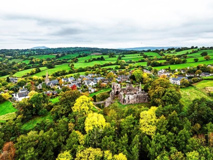 Autumn Colours over ruins of Grosmont Castle from a drone, Grosmont, Monmouthshire, Wales, UK