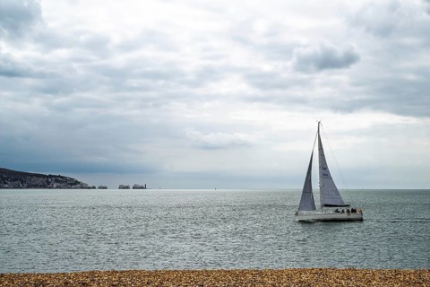 Yacht over Hurst Spit, Milford on Sea, Lymington, Hampshire, UK