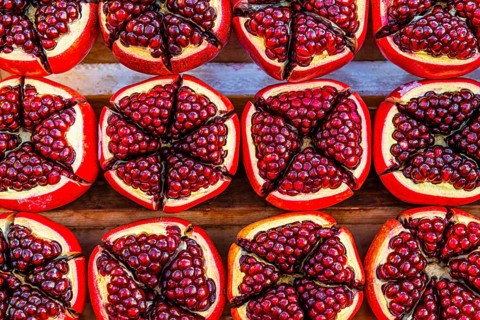 Pomegranate (Punica granatum), halved with red seeds, fruit, food, stand at the Asiatic Riverfront,