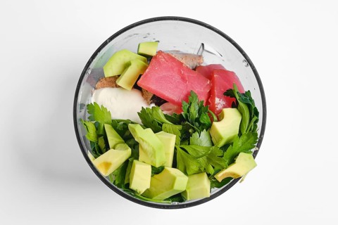 Smoked tuna fillets, avocado, greek yoghurt and parsley in a bowl of hand blender. This healthy