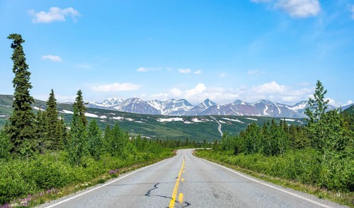 Road through taiga and mountainous landscape, picturesque landscape on Richardson Highway, Alaska,