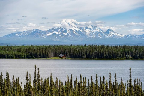 House on Lake Willow Lake, Taiga landscape with high glaciated mountain peak Mount Drum, Wrangell