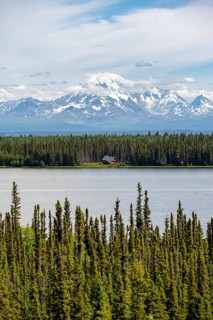 House on Lake Willow Lake, Taiga landscape with high glaciated mountain peak Mount Drum, Wrangell