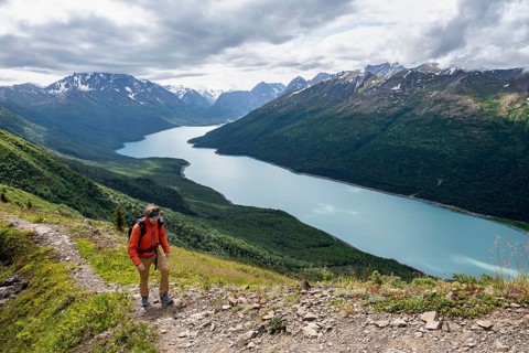 Climbers on a hiking trail, view of blue lake and mountains on Twin Peaks Trail, Eklutna Lake,