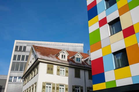 Modern architecture meets historic architecture, city view with colorful facades and clear blue