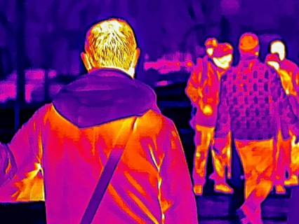 Thermal image or thermography, symbolic photo, interpolated. People traveling in urban areas.
