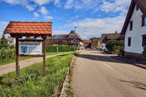 Tourist sign Hohnhurst - southernmost village in Hanauerland, houses, general development, road,