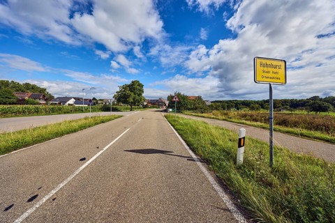 Town entrance sign, general development, building, road, guide post, trees, grass, forest, blue
