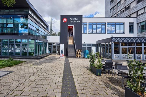 Employment agency, modern architecture, commercial building, outdoor area of a restaurant, cloudy,