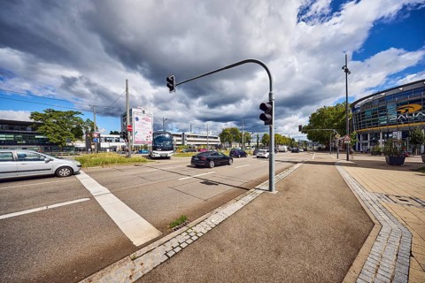 Traffic light crossing, general architecture, train station, sidewalk, cycle path, road, cars,