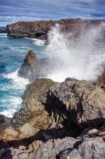 Coastal scene with waves breaking against rocks under a cloudy sky, Playa del Janubio, Yaiza