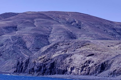 Large rocks and mountains along the coastline that extend into the sea, Playa Quemada, Yaiza