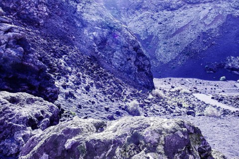 Dry, rocky terrain with rocky formations and soft lighting conditions, El Cuervo volcanic crater,