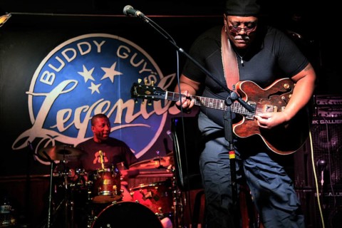A guitarist plays passionately in a blues club, the intensity of the music is palpable, Chicago,