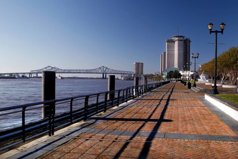 Promenade with high-rise building on the riverbank under clear sky, New Orleans, Louisiana, USA