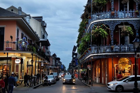 Night view of a busy street in the French Quarter with illuminated shops, New Orleans, Louisiana,