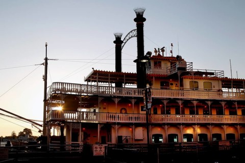 A paddle steamer on the River Front, illuminated at dusk in New Orleans, New Orleans, Louisiana,