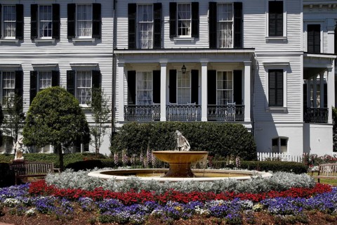 Nottoway Plantation mansion with decorative fountain and colorful flower bed, zero