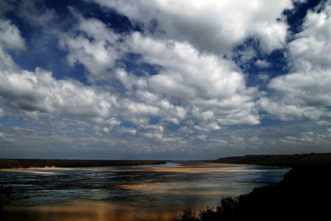 Wide river landscape with sandbanks under dramatic cloudy sky, Natchez, Mississippi, USA
