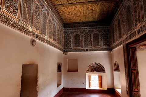 Richly decorated interiors of Kasbah Taourirt with ornate ceilings and traditional Moroccan
