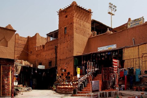 Traditional kasbah with souk, where sand-colored facades dominate the picture, Ouarzazate, Morocco