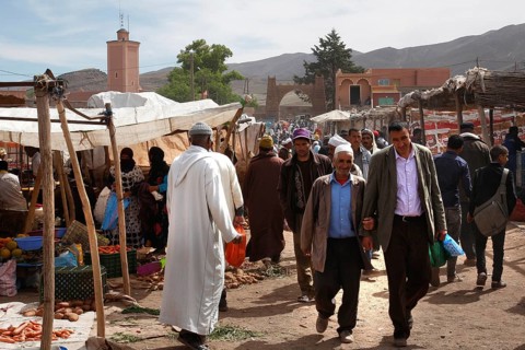 Market scene in Msemrir with people walking along the stalls, Msemrir, Morocco