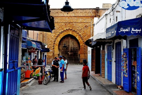 Historic street in the Kasbah des Oudaias with archway and blue facades, Rabat, Morocco