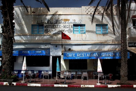 Blue and white café in Sidi Ifni with Moroccan flag and palm trees, Sidi Ifni, Souss-Massa, Morocco
