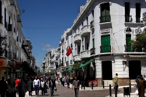 Bustling Avenue Mohammed V in Tetouan with white buildings and passers-by, Tetouan, Morocco