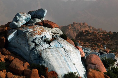 Monumental blue rocks tower over the desert plain in Tafraoute, designed by Jean Verame, Tafraoute,