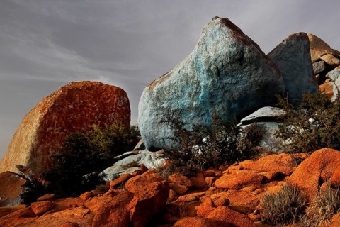 Blue painted stones in the barren desert landscape of Tafraoute by Jean Verame, Tafraoute,