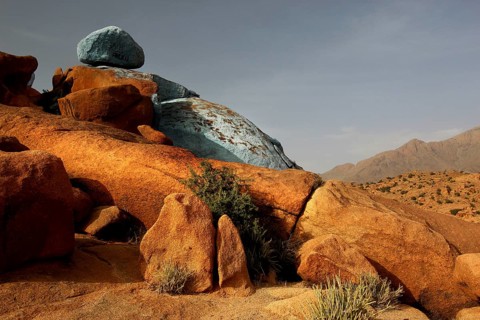 Blue and red rocks by Jean Verame in the desert landscape of Tafraoute, Tafraoute, Souss-Massa,