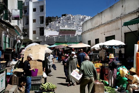 Bustling market in the new town of Tetouan with sellers and customers under umbrellas, Tetouan,
