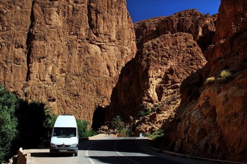 A white transporter drives through the impressive rocks of Todra Gorge, Todra, Gorge