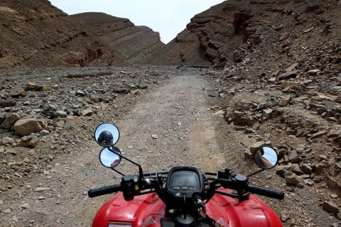 View from a motorcycle of a narrow, rocky path in a gorge, Tizgui n'Ouadda, Morocco