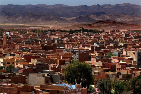Overview of the city of Tinerhir with roofs and mountains behind them, Tinerhir, Morocco