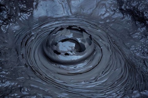 Blowing mud hole in the Whakarewarewa geothermal area in Rotorua, Rotorua, New Zealand