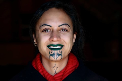 Portrait of smiling person with a Maori tattoo, Rotorua, Te Puia, New Zealand