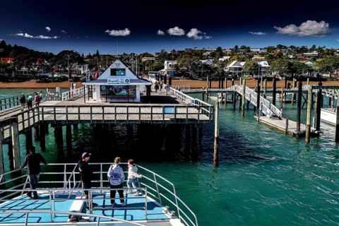 Russell Harbour with jetties and boats on blue water, Russel, Northland, New Zealand