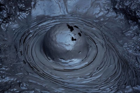 Bubbling mud hole in Whakarewarewa geothermal area, showing raw forces of nature, Rotorua, North