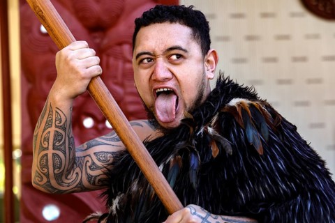 Maori warrior in traditional garb shows impressive expression of performance, Waitangi, New Zealand