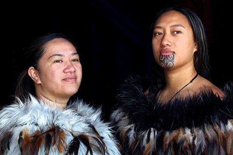 Two woman in traditional Maori garments pose for a portrait, Waitangi, New Zealand