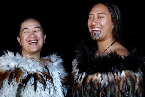 Two laughing woman in Maori robes radiate joy and community, Waitangi, New Zealand