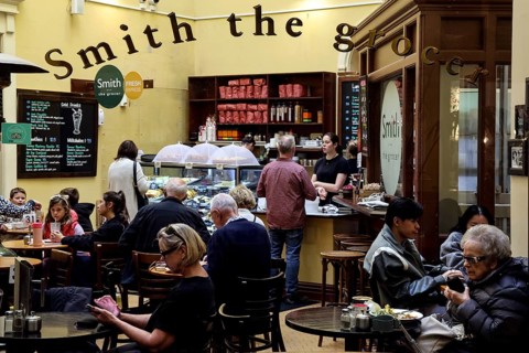 Bustling café in Old Bank Arcade with people at tables in Wellington, Wellington, New Zealand